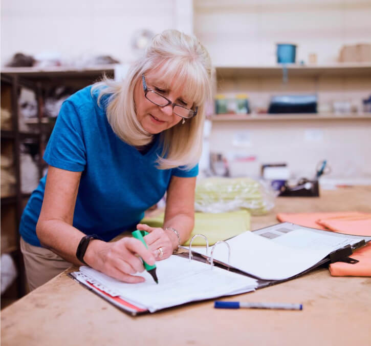 Lady writing in book