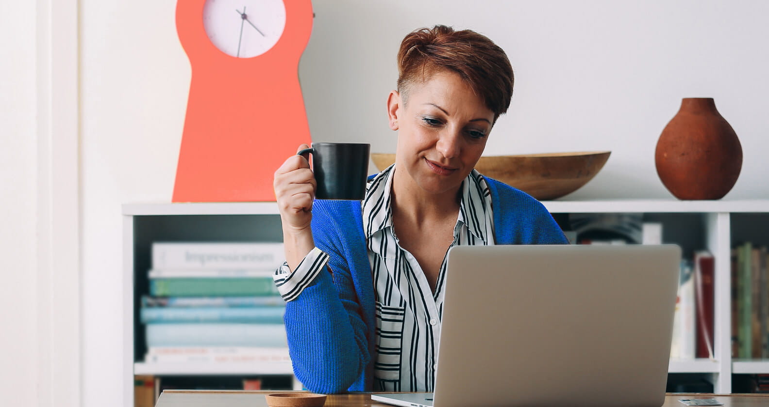 Lady browsing on computer with coffee