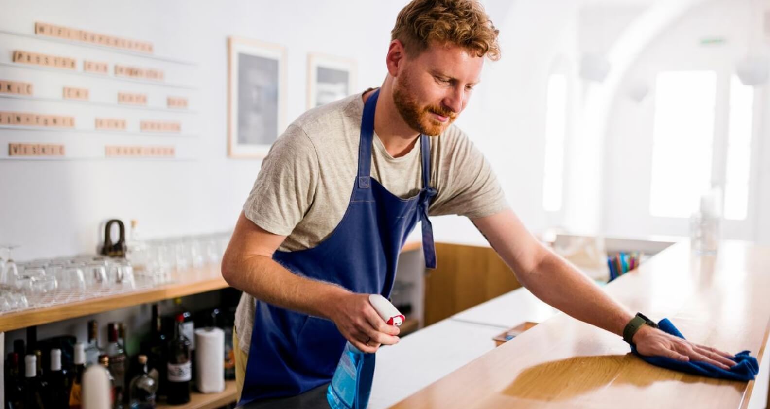 Man cleaning table in cafe