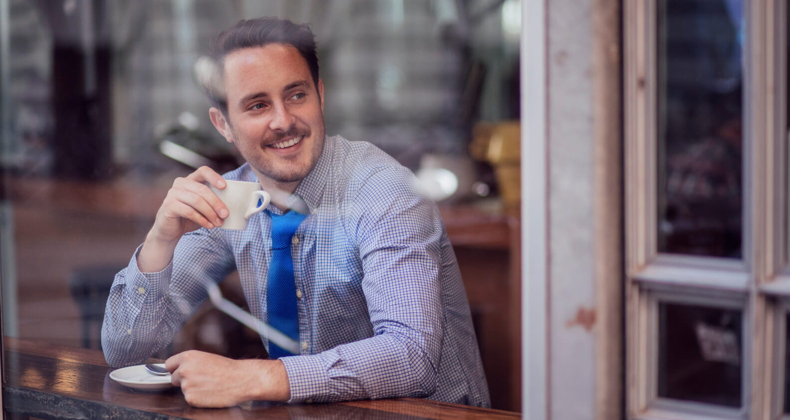 Man at cafe drinking coffee