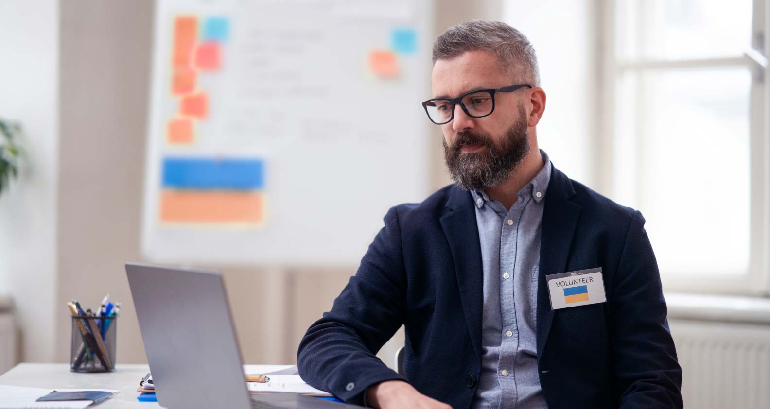 Unhappy worker staring at laptop