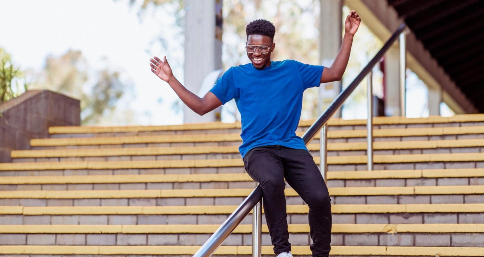 Man sliding on handrail