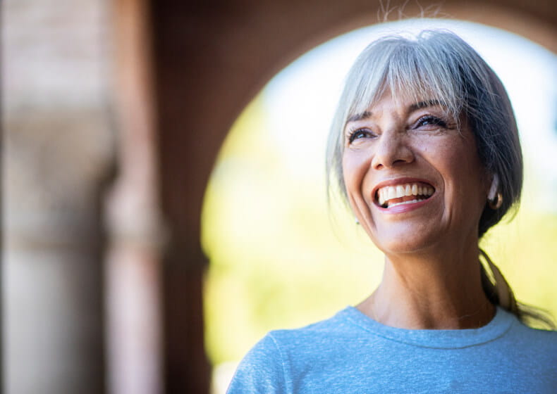 Woman smilling under bridge