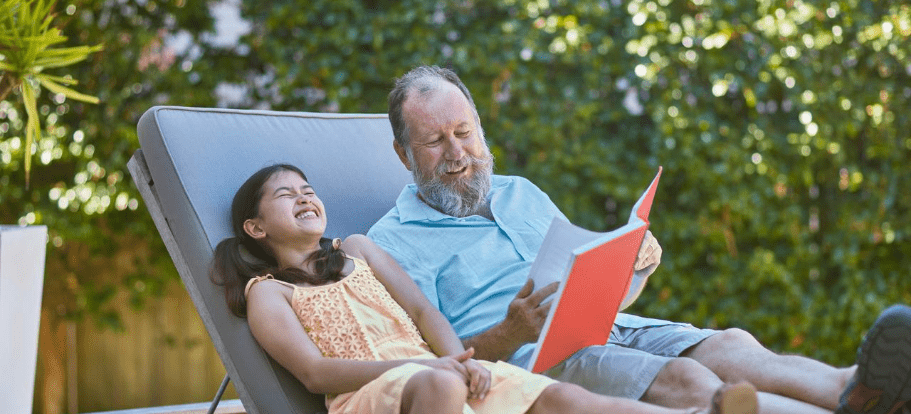 Grandpa reading to grand-daughter