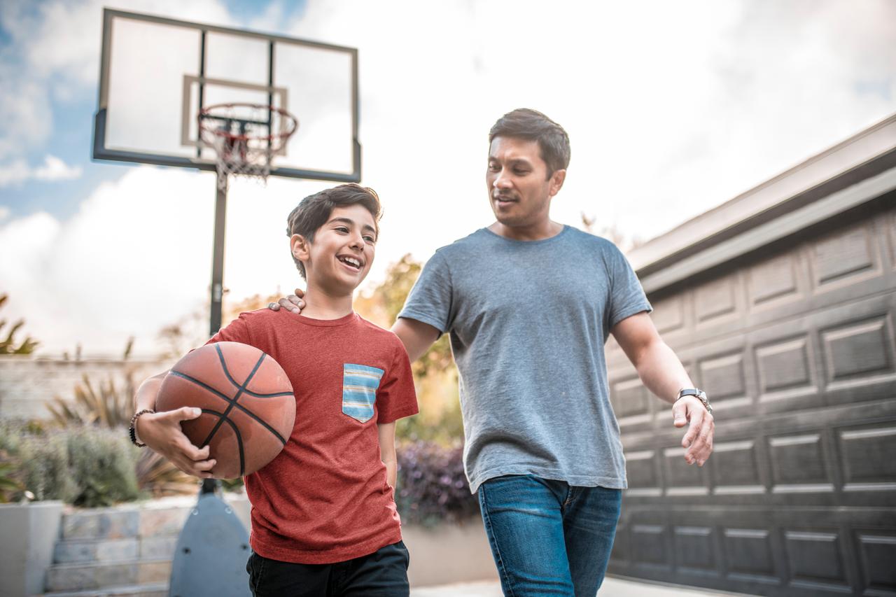 Father and son playing basketball