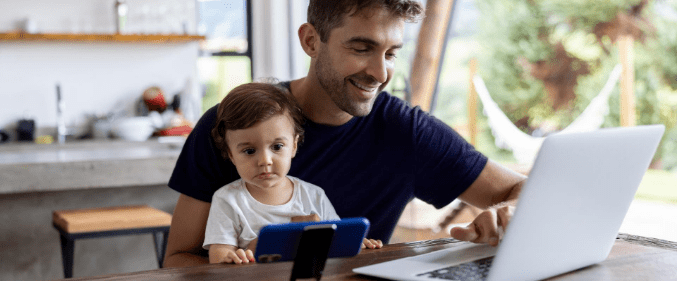 Man with baby looking at laptop